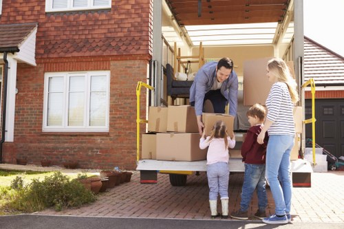 Local removals team handling a house move in Enfield residential street