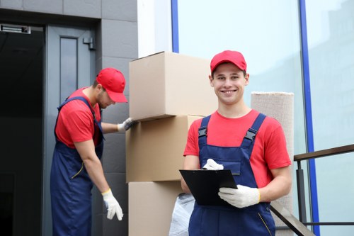 Worker using safe lifting techniques with moving equipment